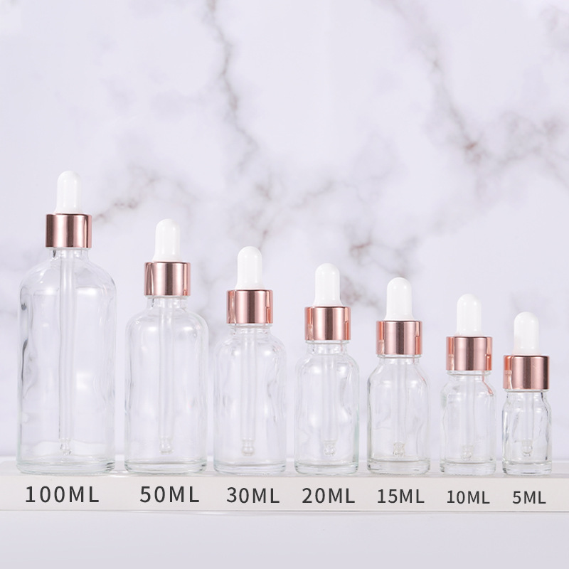 Clear glass cosmetic dropper bottles with rose gold caps
